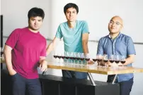  ??  ?? Ava Winery’s Josh Decolongon (top) with Ava’s lab-made wine. Above: Winery co-founders Mardonn Chua (left), Alec Lee and Decolongon in their Dogpatch lab.