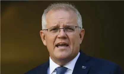  ?? Photograph: Lukas Coch/EPA ?? Scott Morrison speaks to the media on Monday. The PM announced that isolation rules will not apply to close contacts of Covid cases working in essential supply chain roles.