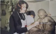  ??  ?? Marica Azzopardi Balzan sculpting a cupid with vase for an outdoor water fountain during one of the modelling classes at the School of Art