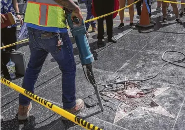  ?? David McNew / AFP/Getty Images ?? Less than two weeks after a man used a pickax on Donald Trump’s star on the Hollywood Walk of Fame, the City Council of West Hollywood has asked that it be removed, in part because of the way he treats women.