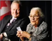  ?? THE CANADIAN PRESS/JOHN WOODS ?? Clutching some $10 banknotes Wanda Robson, Viola Desmond's sister, speaks at a launch of Canada's new $10 banknote, which has a portrait of Desmond, the first Canadian woman on a banknote, at the Canadian Museum For Human Rights in Winnipeg, Monday. Bank of Canada Governor Stephen Poloz and Robson, officially launched the unique, vertically oriented purple bill.