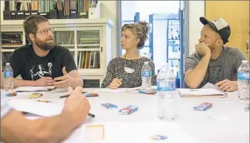  ?? Antonella Crescimben­i/Post-Gazette ?? Jared Ondovchik, left, talks about his company, Artifact Metalworks, with other business owners at a peer-to-peer mentoring session held by the Mansmann Foundation.