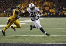  ?? MATTHEW PUTNEY — THE ASSOCIATED PRESS ?? Iowa linebacker Djimon Colbert, left, can’t stop Penn State running back Noah Cain from scoring on a five-yard run in the fourth quarter that clinched a 17-12victory for the Nittany Lions Saturday night.