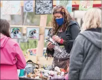  ?? SUBMITTED PHOTO ?? Bronwyn DeMaso, center, came up with the idea of pairing the art fair with the Edgewood Cemetery Art Fair and Cleanup. She is seen here Saturday, examining some of the wares for sale.