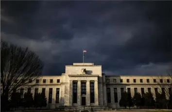  ?? Samuel Corum/Bloomberg ?? The Marriner S. Eccles Federal Reserve building in Washington, D.C. Every income group has seen balances drop from a 2021 peak, according to a Fed survey. Among the wealthiest onefifth of households, cash savings remain about 8% above their level when the pandemic hit.