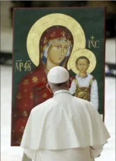  ?? GREGORIO BORGIA - THE ASSOCIATED PRESS ?? Pope Francis prays in front of an icon of the Virgin and baby Jesus during an audience with pilgrims from Slovakia in the Paul VI Hall at the Vatican, Saturday.