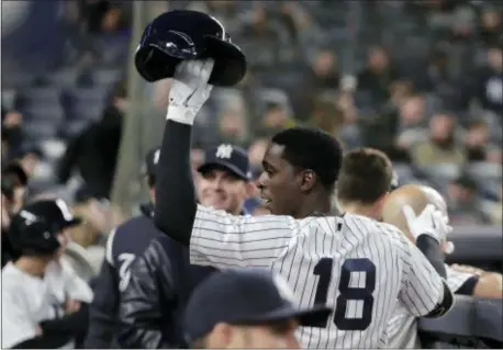  ?? JULIE JACOBSON — THE ASSOCIATED PRESS ?? New York’s Didi Gregorius (18) raises his helmet against the Marlins Monday in New York. to the crowd after hitting a solo home run, his second of the game,