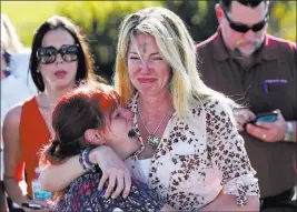  ?? Joel Auerbach The Associated Press file ?? Mechelle Boyle, right, embraces Cathi Rush as they wait Feb. 14, 2018, for news on the mass shooting at Marjory Stoneman Douglas High School in Parkland, Fla.