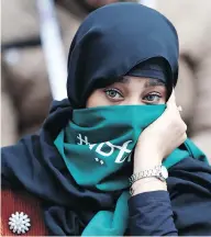  ?? HASSAN AMMAR / THE ASSOCIATED PRESS ?? A Saudi woman watches the Group A match between Russia and Saudi Arabia to open the 2018 World Cup at the Luzhniki Stadium in Moscow on Thursday.