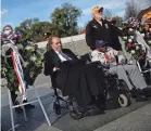  ?? WIN MCNAMEE/GETTY IMAGES ?? Former Sen. Bob Dole, left, visits the World War II Memorial in Washington, D.C., in 2016.