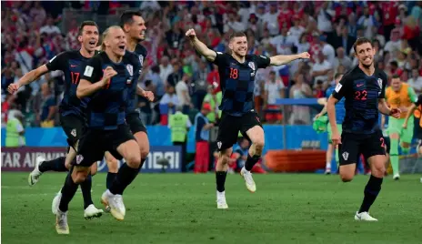  ?? AFP ?? Croatia’s players celebrate after beating Russia on penalties to reach the World Cup semifinals in Sochi on Saturday. —