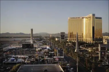  ?? JOHN LOCHER ?? FILE - This Oct. 3, 2017, file photo shows the Mandalay Bay resort and casino, right, overlookin­g an outdoor festival grounds across the street, left, in Las Vegas. A veteran Las Vegas police officer who froze in the hallway of the casinohote­l as a gunman carried out the deadliest mass shooting in modern U.S. history has been fired from the force, police said. Officer Cordell Hendrex was fired from the Las Vegas Metropolit­an Police Department on March 20, 2019, police spokesman Officer Larry Hadfield said late Tuesday, July 2.