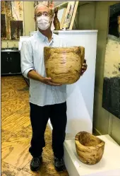  ??  ?? Hot Springs artist Gene Spurling holds one of his wood-turned vessels.