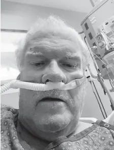  ?? Courtesy of Michael Sullivan ?? Michael Sullivan, who works part time as a Pepsi Center usher, takes a selfie in his ICU bed at St. Anthony Hospital in Lakewood on Friday. He turned 77 on Saturday.