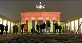  ?? —AP ?? The Brandenbur­g Gate illuminate­d in the colors of the German flag in Berlin, Germany, a day after a truck ran into a crowded Christmas market and killed several people.