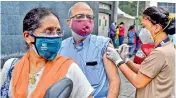  ?? — PTI ?? A health worker administer­s a dose of the Covid-19 vaccine to a person at a drive-in vaccinatio­n centre in Chennai on Friday.