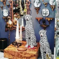  ?? David Medford ?? An ornate gilt mirror and tall porcelain cheetahs are among the inventory in San Antonian David Medford’s ReVAMP booth.