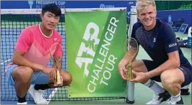  ??  ?? Benjamin Lock (right) and his Taiwanese playing partner Yu Hsiou Hsu pose with his trophies after winning the doubles title in the President's Cup in Nur-Sultan, Kazakhstan on Saturday