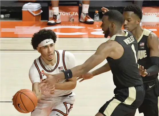  ?? AP ?? Illinois’ Andre Curbelo passes around Purdue’s Aaron Wheeler and Eric Hunter Jr. on Saturday in Champaign. Curbelo had six assists to add to his Big Ten- leading total.