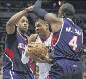  ?? DARREN HAUCK / AP ?? Hawks center Al Horford and forward Paul Millsap double-team the Bucks’ Giannis Antetokoun­mpo during the first half of Sunday’s game. The Hawks forced a season-high 25 turnovers.