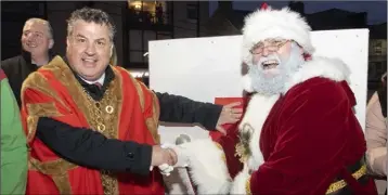  ??  ?? Mayor George Lawlor and Santa Claus turn on the Wexford Christmas lights.