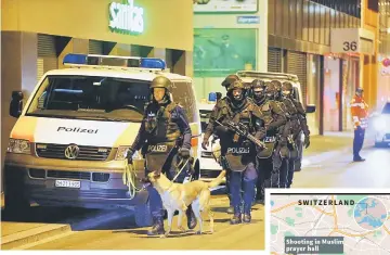  ??  ?? Police stand outside an Islamic center in central Zurich, Switzerlan­d. — Reuters photo