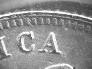  ?? ?? Figure 2: Tool mark on a counterfei­t from the rim over the “C.”