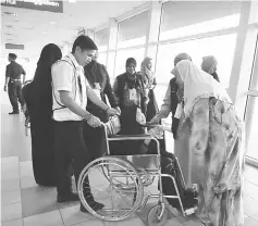  ??  ?? Hamdiah (right) chats with Jainap (on wheelchair) at the departure hall of Bintulu Airport.