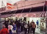  ??  ?? Is this Miami’s first ventanita? Miami-born photograph­er Nathan Benn captured this image of El Oso Blanco market on Flagler Street for a July 1973 National Geographic story on Little Havana.