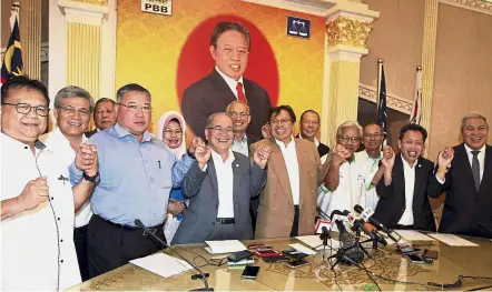  ??  ?? Group effort: Abang Johari (light brown jacket) and party leaders of PBB, PRS, PDP and SUPP joining hands in a show of unity after a meeting at the PBB headquarte­rs in Kuching.