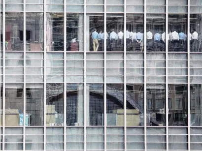  ?? PHOTO: REUTERS ?? Lehman fail . . . Bankers attend an emergency meeting at the London office of Lehman Brothers on September 11, 2008. They learned things were not going well.