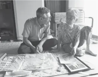  ?? Ahn Young-joon/the Associated Press ?? Hong Jong Soon, 88, right, looks at portraits of husband Park Jong Won with her son Park Yong Ho at their house in South Korea. Hong awaits Park’s return from the Korean War 60 years after the conflict ended.