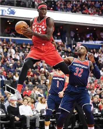  ?? NICK WASS/THE ASSOCIATED PRESS ?? Toronto Raptors forward Pascal Siakam leaps up with the ball against Washington Wizards’ Jeff Green Saturday in Washington. Siakam had 10 points and 10 rebounds coming off the bench.