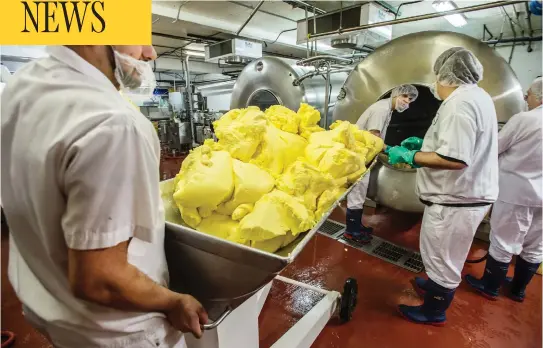  ?? PETER J THOMPSON / NATIONAL POST ?? Alliston Creamery employees churn and package Emerald Grasslands butter.