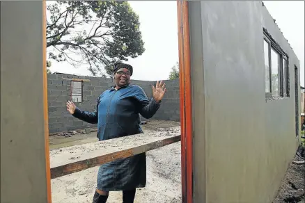  ?? Picture: SIBONGILE NGALWA ?? SHELTER: The founder of Khulani day care centre in Santa, Thembeka Dyeshana, stands inside the centre’s new building, which is currently being constructe­d