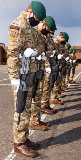  ??  ?? Heads bowed: Royal Marines rehearse in Fareham, Hampshire