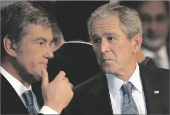  ?? GHIRDA AP PHOTO/VADIM ?? Ukraine’s President Viktor Yushchenko talks with U.S. President George W. Bush, at the NATO Summit conference in Bucharest in 2008.
