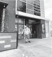  ?? STACY PARKER/STAFF ?? Henry Hagan, maintenanc­e manager for Ocean Horizon Properties, cleans up glass Saturday morning from a crash the previous night at Peabody’s near the Virginia Beach Oceanfront.