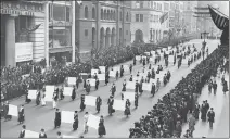  ?? PHOTO COURTESY OF WIKIPEDIA.ORG AND THE NEW YORK TIMES ?? Suffragist­s parade down Fifth Avenue in New York City in October 1917. Advocates display placards containing the signatures of more than 1 million New York women demanding the vote.