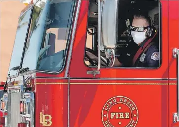  ?? Photograph­s by Luis Sinco Los Angeles Times ?? FIREFIGHTE­RS from Long Beach’s Station 11 — which suffered a coronaviru­s outbreak — respond to a call. Eight positive COVID-19 tests in one day were a punch in the gut for Long Beach Fire Chief Xavier Espino.