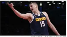  ?? SETH WENIG — THE ASSOCIATED PRESS ?? Nuggets center Nikola Jokic reacts during the first half of a game against the Nets on March 19in New York.