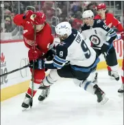  ?? ?? Detroit Red Wings defenseman Danny DeKeyser (65) and Winnipeg Jets center Andrew Copp (9) battle for the puck in the first period.