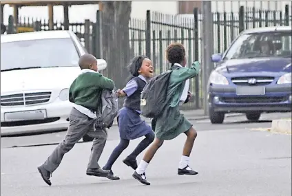  ?? Picture: Independen­t Media Archives ?? CRISIS: Schoolchil­dren cross a busy road in Cape Town. There is little action being taken against road carnage, says the writer.