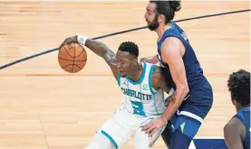  ?? JIM MONE/AP ?? The Hornets’ Terry Rozier (3) tries to work around the Timberwolv­es’ Ricky Rubio on March in Minneapoli­s.