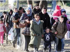  ??  ?? IDOMENI: Migrants and refugees cross the border of Greece and Macedonia near the village of Idomeni, northern Greece yesterday. The European Commission on November 5 estimated that some three million migrants fleeing war and poverty will be entering...