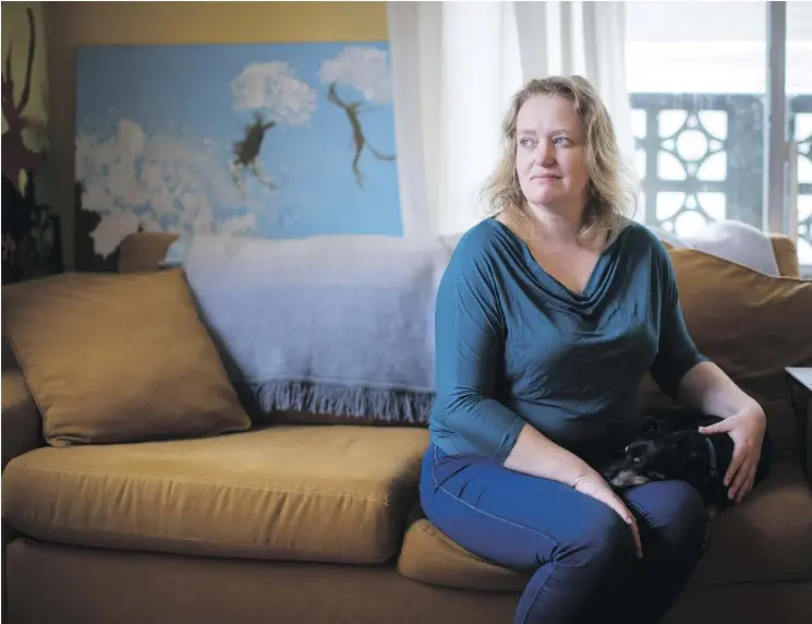  ?? DARRYL DYCK/THE CANADIAN PRESS ?? Joanna Fletcher sits with her foster dog in the one-bedroom apartment where she lives with her 10-year-old son in Vancouver. Despite the threat of eviction, she is fighting to stay for as long as possible because she can’t afford anything else in the...