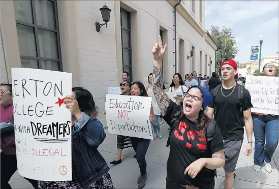  ?? Allen J. Schaben Los Angeles Times ?? STUDENTS MARCH on the campus of Fullerton College last month in solidarity with those who are shielded by the Deferred Action for Childhood Arrivals program.