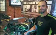  ??  ?? History Channel celebrity Steve Hale admires a 1934 Harley-Davidson his firm restored. It will be sold in the first-ever Saratoga Auto Auction.