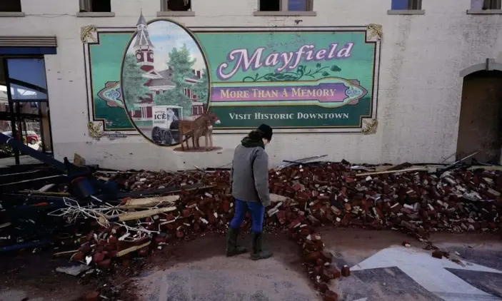  ?? Photograph: Mark Humphrey/AP ?? Damage from a tornado is seen in downtown Mayfield, Kentucky, on Saturday.