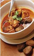  ??  ?? Tedious preparatio­n: Ayam Buah Keluak is a curry dish with chicken pieces and buah keluak.